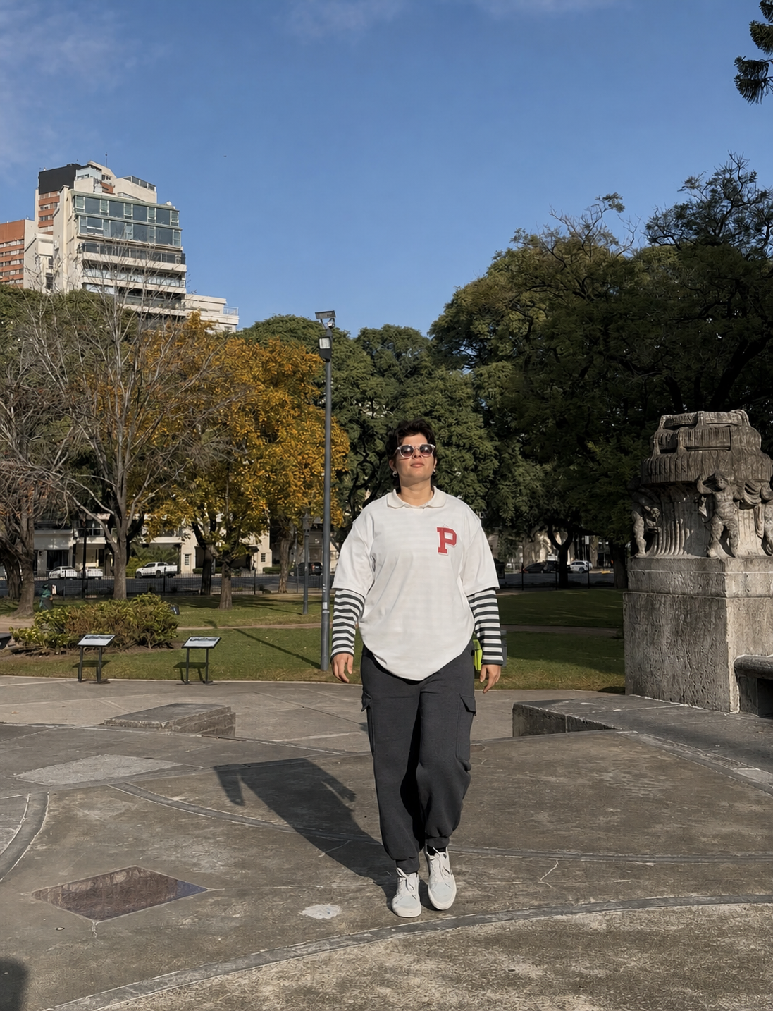 Marri walking through a sunny city park